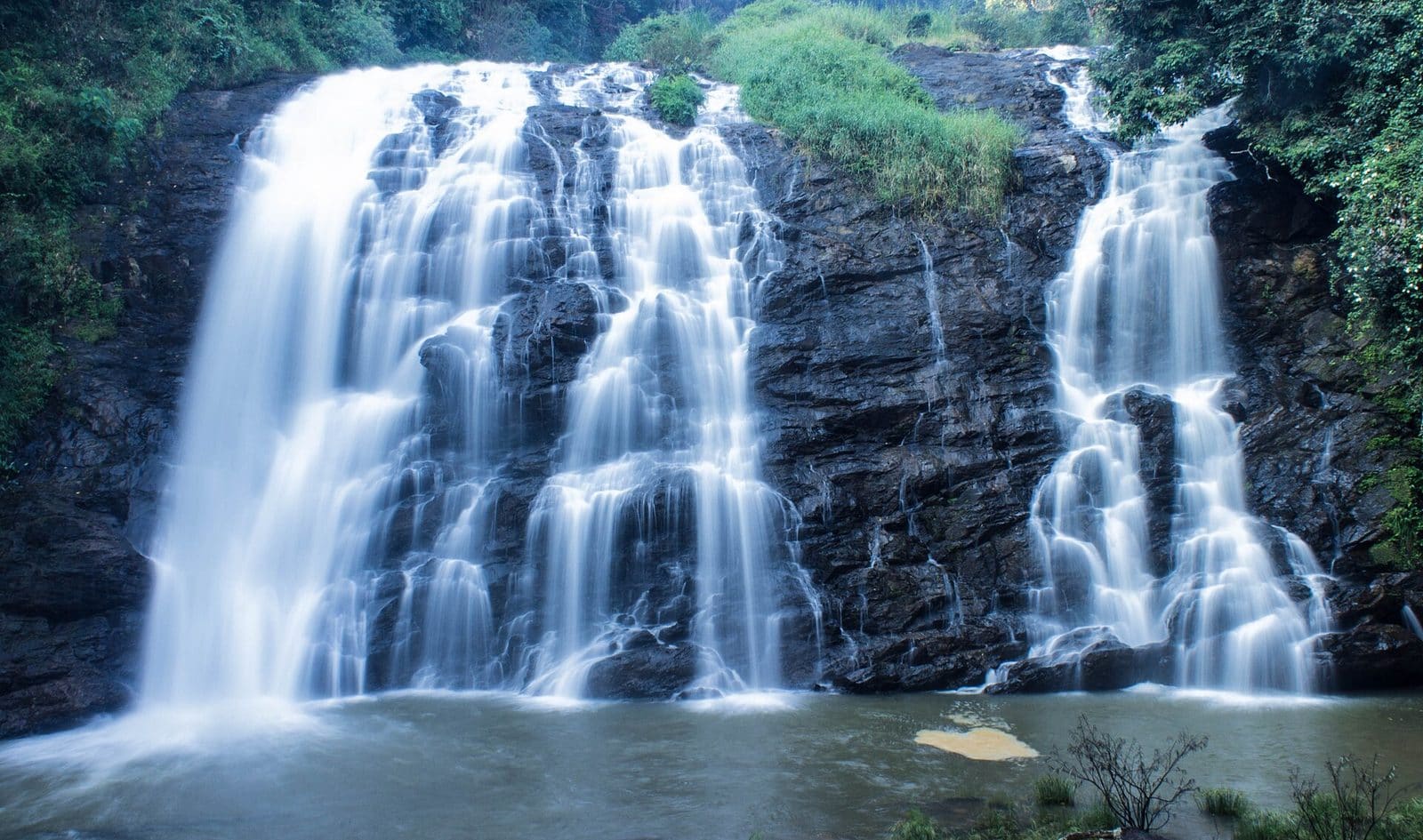Abbey Falls tumbling through dense green forest near Madikeri, Coorg