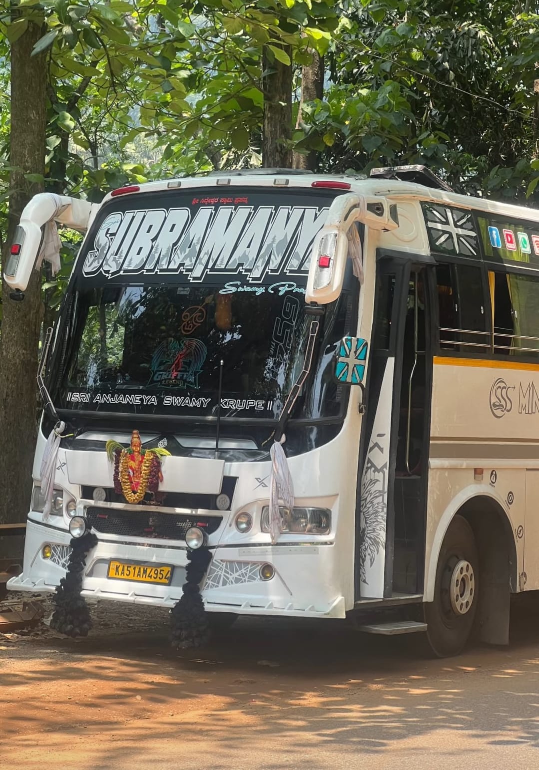 Coach on a tree-lined highway for an outstation trip