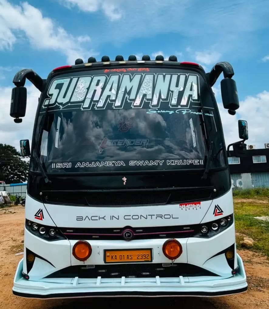 A Sri Subramanyaswamy Tours & Travels tourist coach, front view, under a bright sky